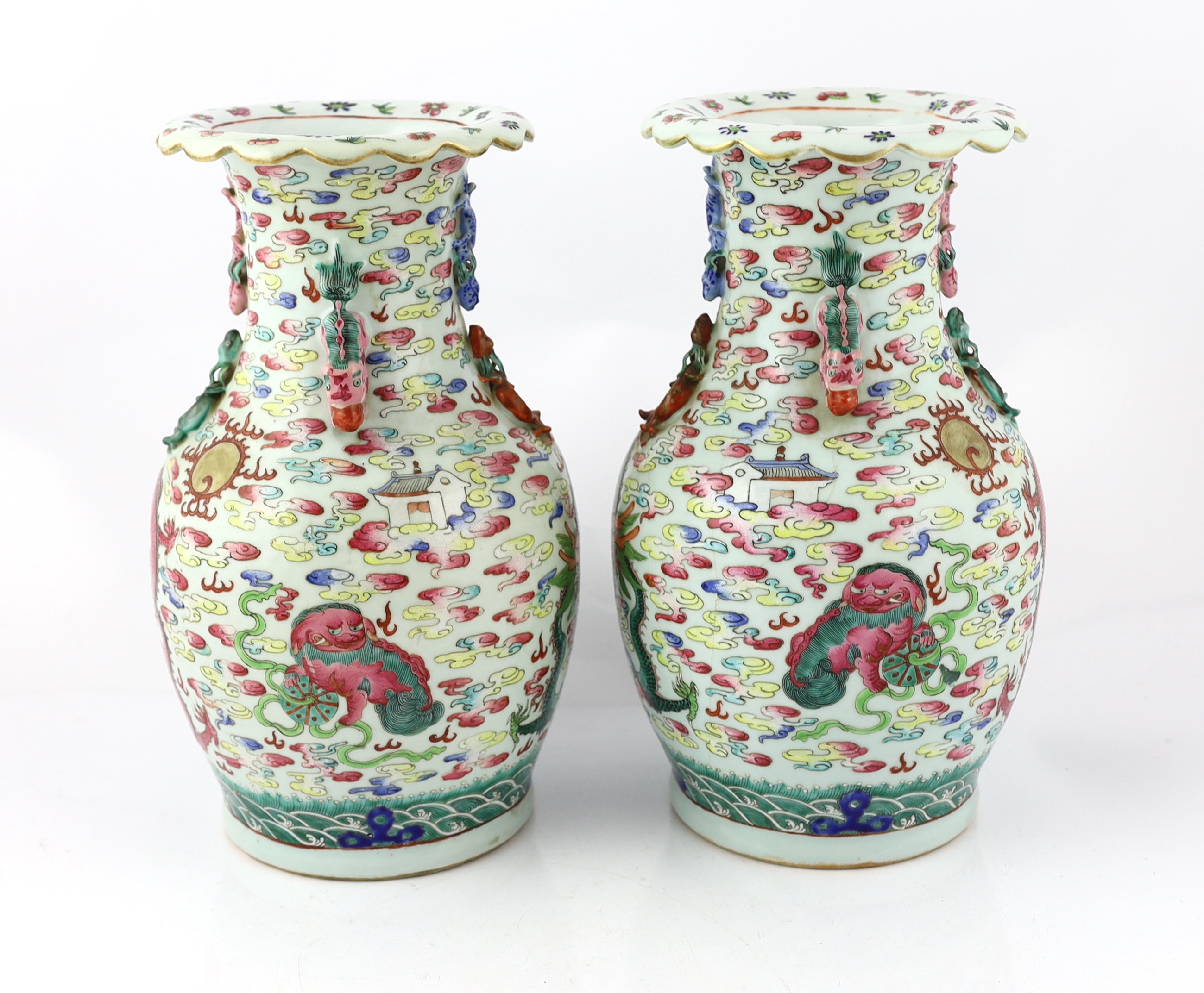 A pair of Chinese enamelled porcelain 'dragon and Buddhist lion' vases, 19th century, body crack to one vase